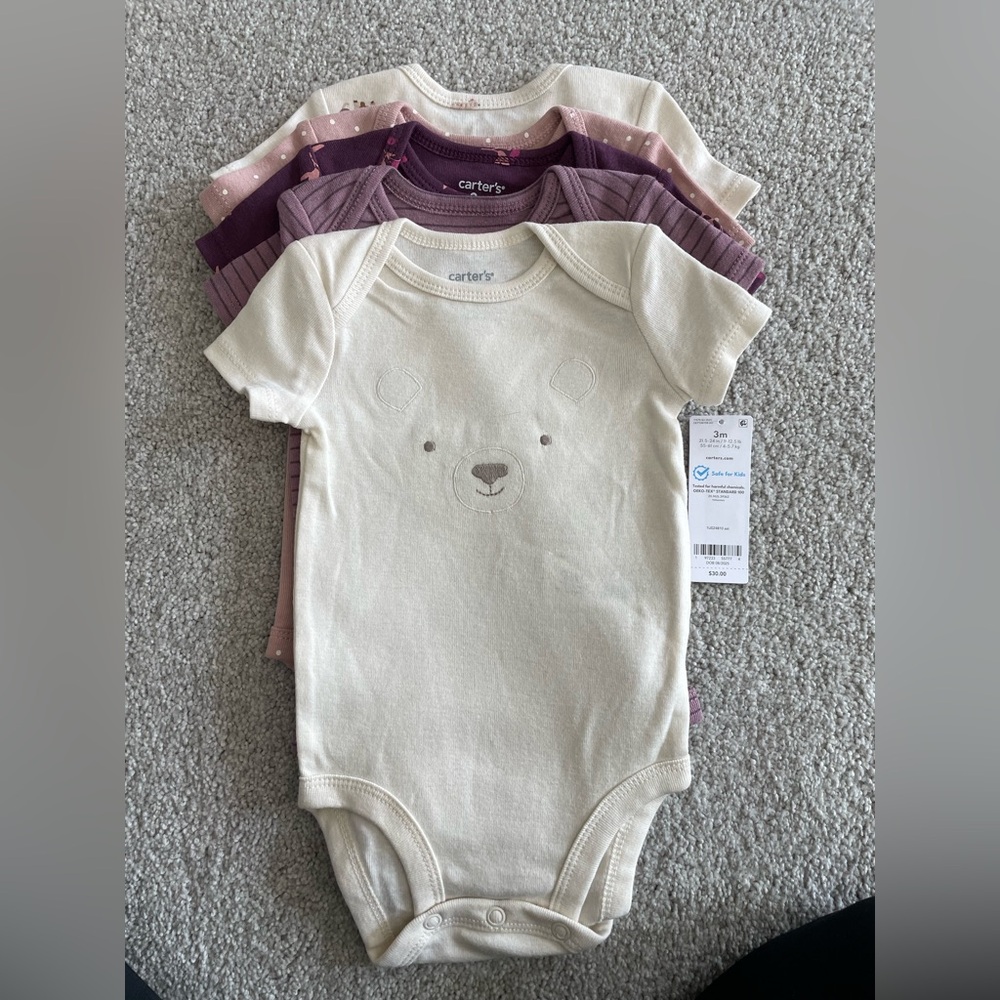 Carter's packet of Cream and Purple onesies.
